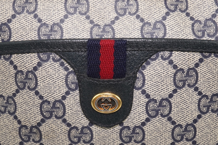 Three vintage Gucci handbags, two canvas blue GG monogram and the other black leather